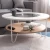 Import Modern durable living room furniture metal frame round glass top coffee table with mdf covered shelf from China