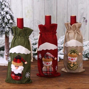 Christmas decorations:   red wine bottle, wine bag, restaurant table