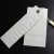 Import white card paper emboss logo garment 3D hang tag with swing string from China