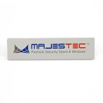 Simple decorative metal tag for furniture with adhesive