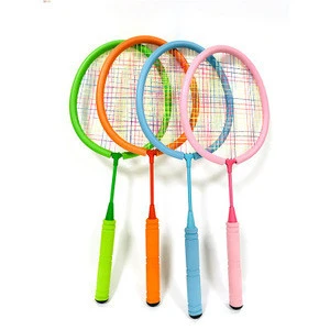 Children&#39;s badminton toys play in the garden at home to exercise tennis training