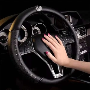 Car set with diamond swan car steering wheel cover female universal leather perforated breathable rivet cover personality.