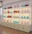 Import Custom MDF wooden cosmetic stand make up perfume shop design display showcase cabinet from China