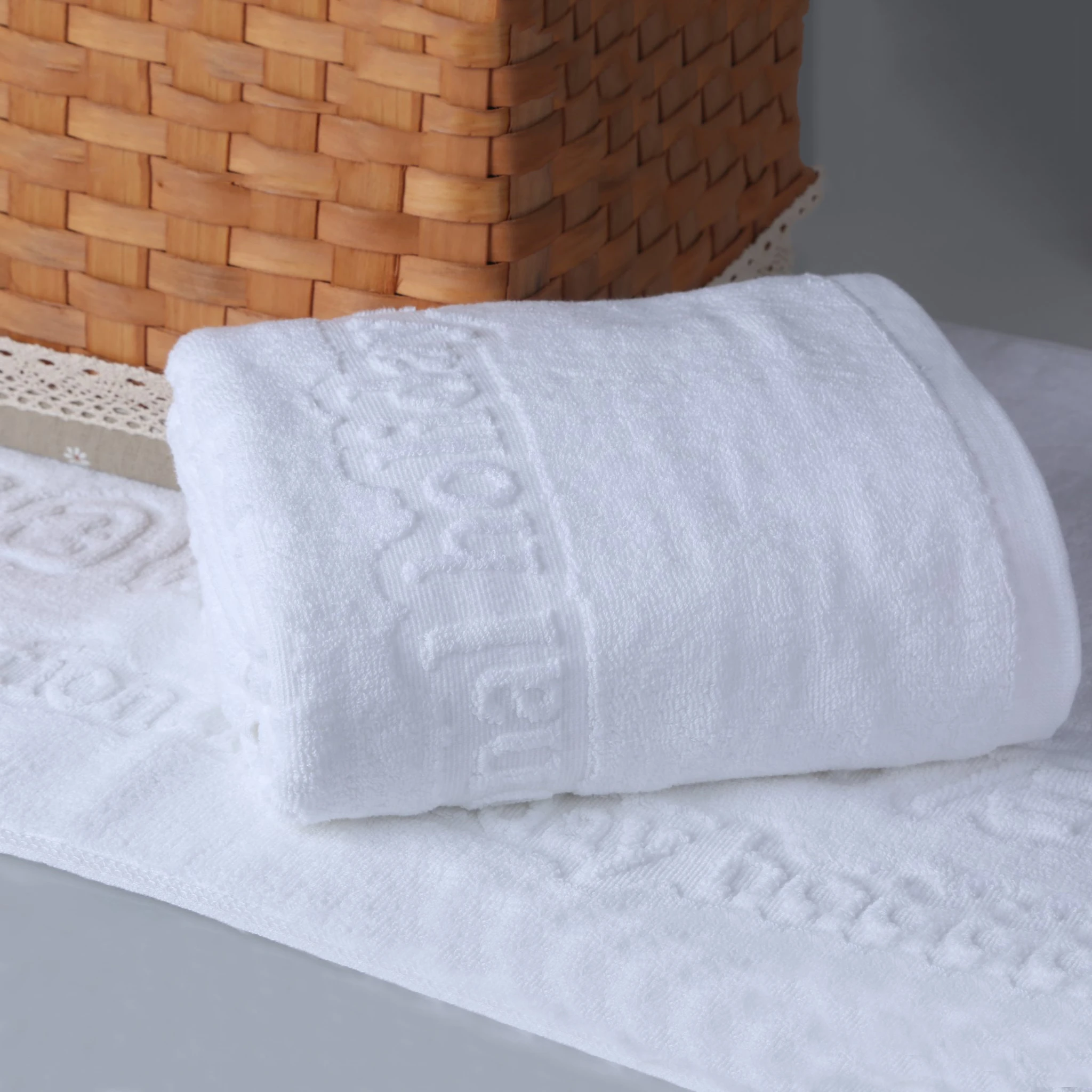 Guangzhou hotel towels manufacturer customize embossed logo cheap bath towels hotel wholesale