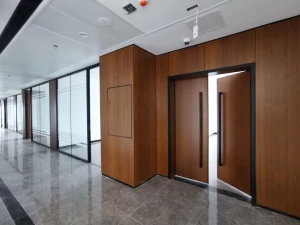 Single glass partition and brown wood dado