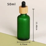 essional oil dropper glass bottle 2024 new arrival empty round RTS green with bamboo dropper skin care serum cosmetic packaging