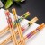 Import Hot Sale Bulk Cheap Prices Japanese Korean Style Printed Reusable Bamboo Wood Sushi Chopsticks from China