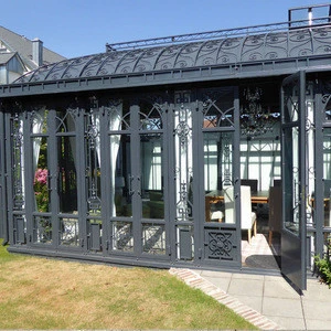 Large wrought iron gazebo with metal solid roof and glass to keep rain out, metal sunroom