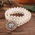 Import rhinestone buckle pearl beaded braided belt women pearl beaded stretch elastic belt pearl weave stretch belt stock available from China